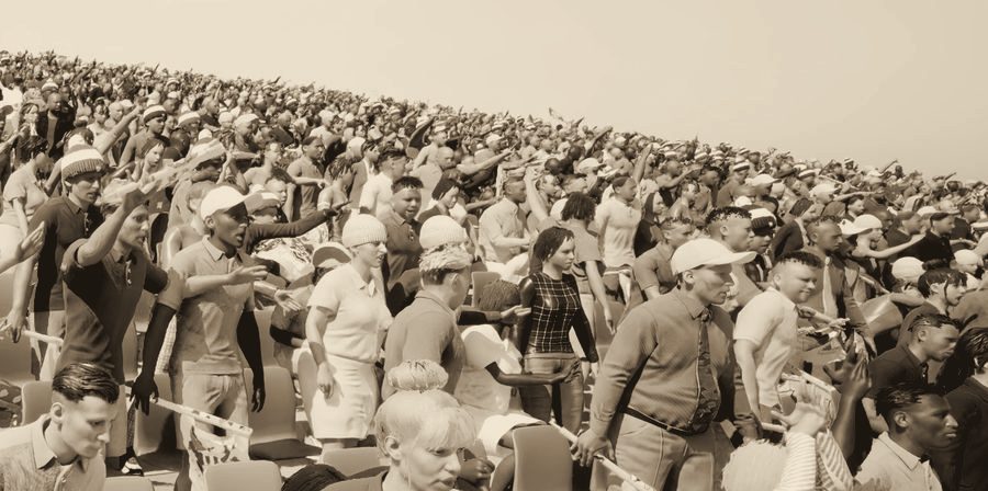 A crowd stretching up a stadium stand